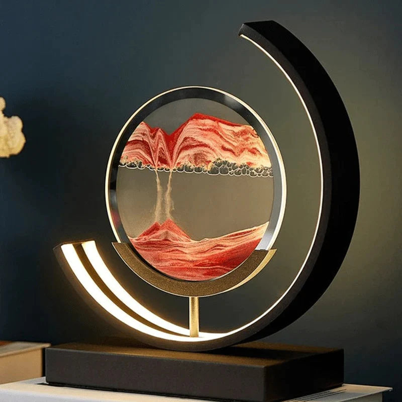 Snugly moving sand art lamp glowing on a table, red sand landscape inside a round glass frame